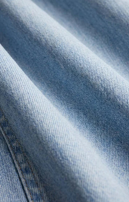 THE SHOW OFF HIGH-RISE BOWED DENIM IN INDIGO BLOOM