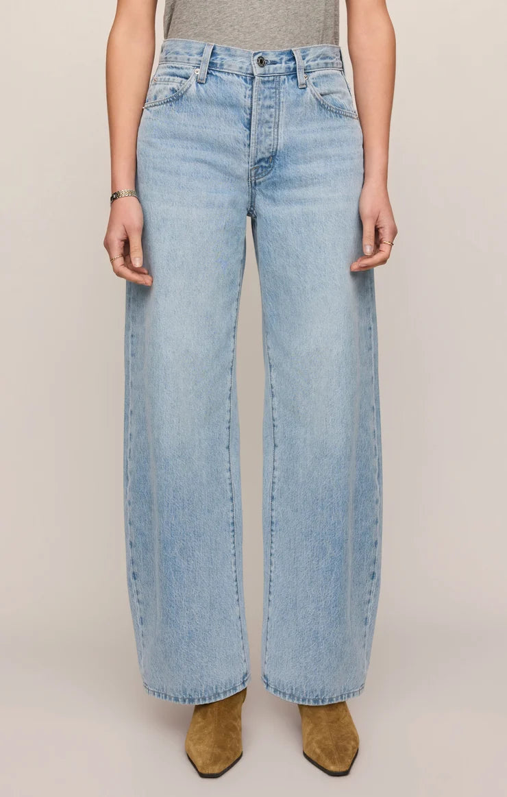 THE SHOW OFF HIGH-RISE BOWED DENIM IN INDIGO BLOOM