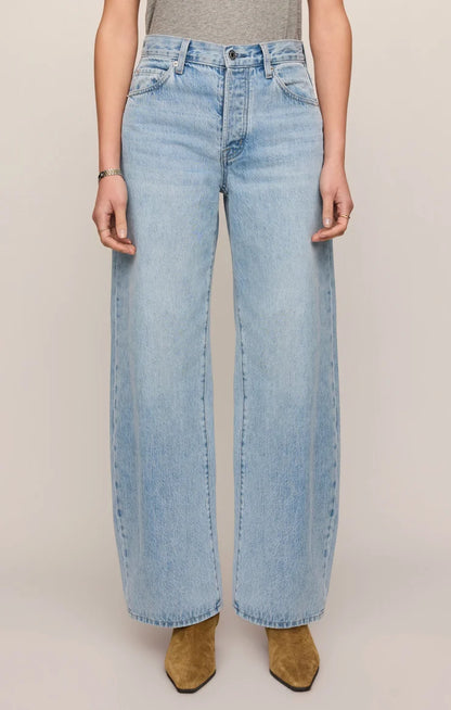 THE SHOW OFF HIGH-RISE BOWED DENIM IN INDIGO BLOOM